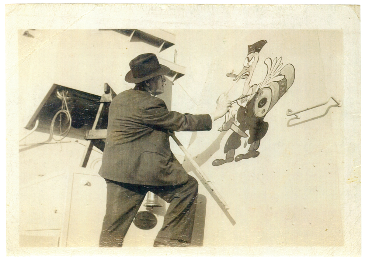 Photo of Lou Skuce painting the  hull of the H.M.C.S. Middlesex
